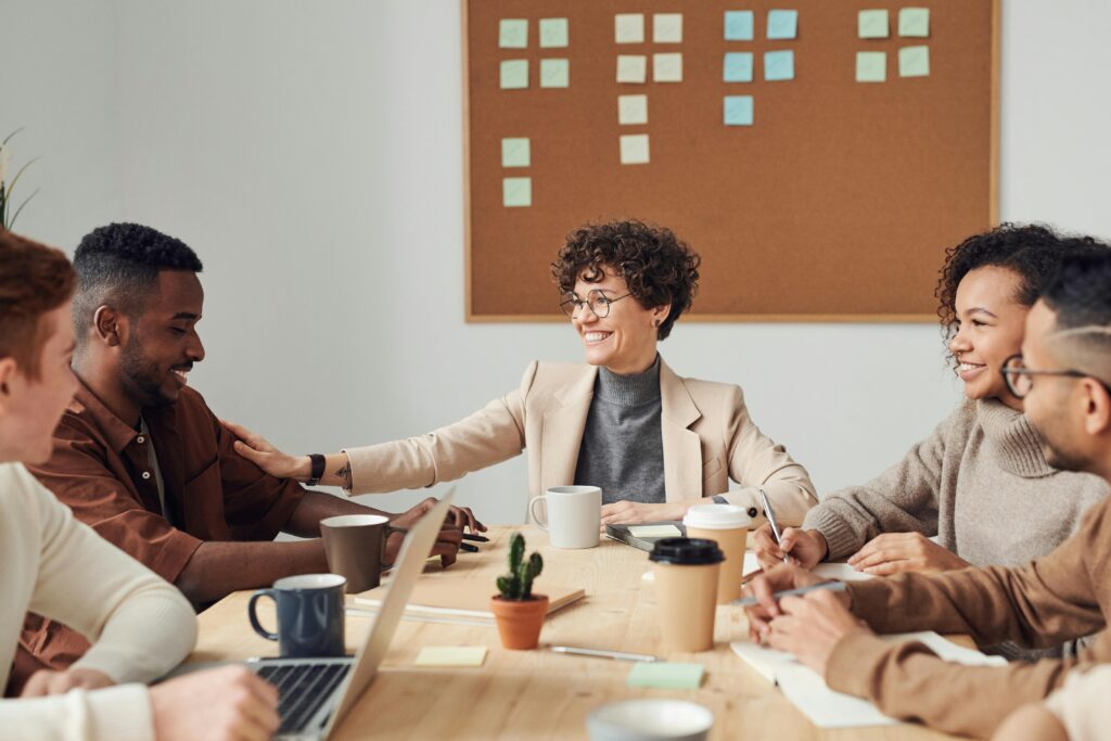 Professional team members collaborating in an office, shaking hands, and a female profile portrait.